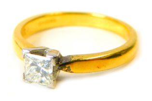 An 18ct gold diamond solitaire ring, the square cut diamond approx 0.50ct, in four point claw white