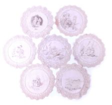 A set of seven lace and linen doilies, each printed centrally with scenes from Alice in Wonderland i