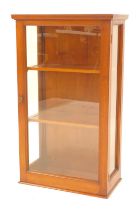 A 20thC mahogany counter top shop display cabinet, with glass fronted door and sides enclosing two s
