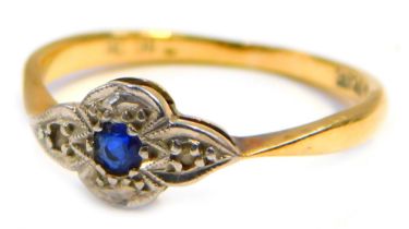 An Art Deco dress ring, the white gold set with tiny diamonds with a central sapphire, pave set in w