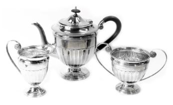 A George V silver tea service, comprising teapot, milk jug and sugar bowl, each of Neoclassical desi
