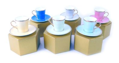 Six Faberge Royal Collection cups and saucers, with gilded rims and handles, in presentation boxes.