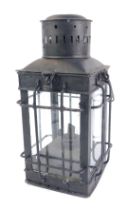 A 20thC lantern, overpainted in black, of square set form with caged detail over panelling, 34cm hig