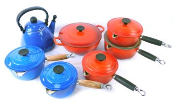 A collection of Le Creuset and Cousances pots and pans, comprising a red Le Creuset casserole dish