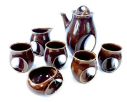 A Holkham pottery brown glazed coffee set T112, comprising coffee pot, four cups, milk jug and sugar