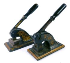 Two 19thC letter presses, each painted black with floral gilding, 22cm high. (AF)