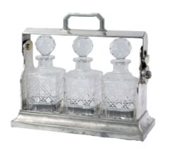 A 20thC silver plated Tantalus, with three cut glass decanters and stoppers, the stand is stamped
