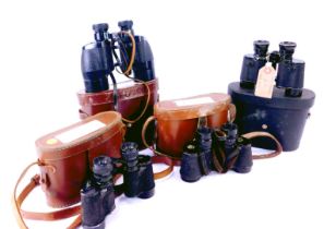 Four pairs of binoculars in a leather case, comprising Auteuil 8x26 binoculars, Nikon 8x30 binocular