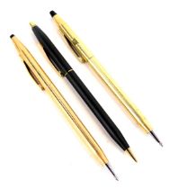 Three Cross ballpoint pens, one in gold coloured casing marked P&D Nigeria, another in rose coloured