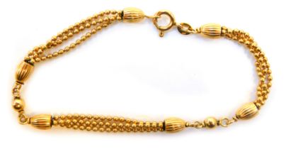 A 9ct gold fancy link bracelet, with three chain link design, and rubbed and hammered links in the E