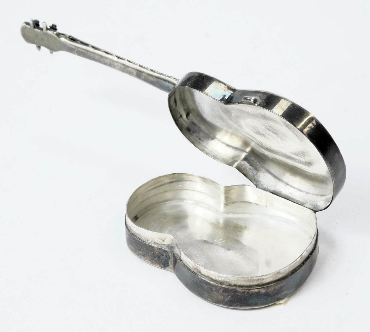 A novelty guitar pill box, formed in the shape of a guitar, the base opening, white metal, London 19 - Image 2 of 3