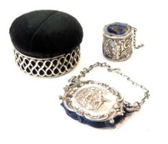 An early 20thC silver pin cushion box, the black velvet overstuffed lid opening to reveal a blue sat