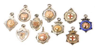 A collection of silver award badges, Bourne & District, c1920 and later, some enamel set with Blue D