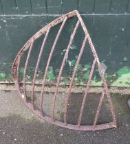 A wrought iron wall mounted corner hay rack, 88cm wide.