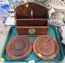 A treen letter rack with inset central clock, together with two collapsible carved wooden bowls. (3)