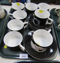 A Grand Hotel by Andrew Martin part coffee service, decorated with white elephants against a black g