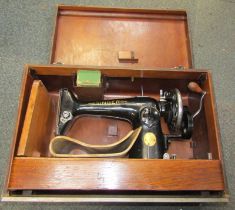 A cased Singer sewing machine.