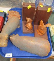 Two carved wooden bookends, with a Dachshund and Scottie dog, two pottery hippos, and a warthog wall