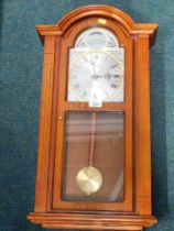 An Actim pine cased wall clock.