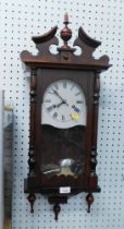 A mahogany cased wall clock, with silvered and Roman numeric dial.