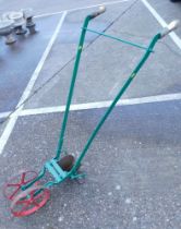 A green painted two rung cultivator.