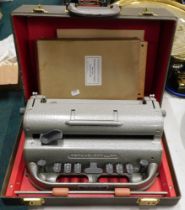 A Perkins brailer machine, in carry case, with small size frame and gripper.