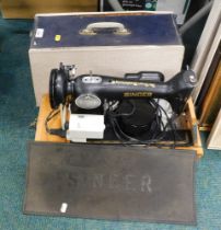 A cased Singer sewing machine and mat.