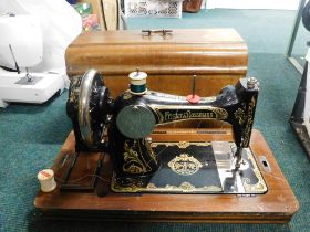 A cased Frister and Rossman sewing machine.