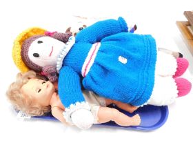 A group of dolls, comprising a knitted girl, a 1960s plastic headed doll, various rag dolls, stuffed