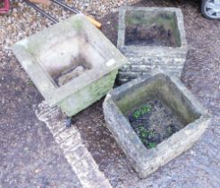 Three reconstituted stone square garden planters, comprising a pair and a fluted example. (3)