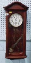 A Hermle mahogany cased drop down wall clock.