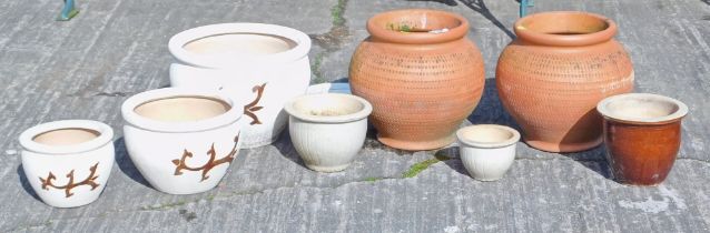 Various garden planters, comprising two terracotta examples, three glazed examples, three