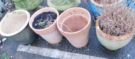 Four plant pots, comprising a glazed circular planter, two terracotta planters, and two ribbed terra