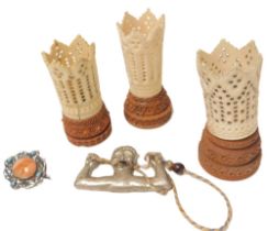 Three bone and wooden dice shakers, silver brooch, and a rattle. (1 bag)