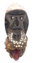 A Dan (Kran) 'Kao gle' Chimpanze divination mask with bells/cowries, Cote D'Ivoire, 34cm high.