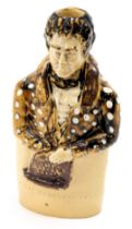 A 19thC Daniel O'Connell esquire slipware bottle, formed as a gentleman with spotted coat, 18cm high