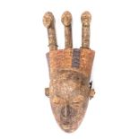 A Koulango three headed divination ancestors mask, Cote D'Ivoire, 72cm high.