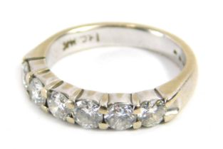 A diamond half hoop dress ring, set with six round brilliant cut diamonds, measuring between 3.35mm