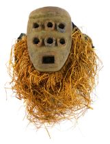 A Grebo (Krou) Maou six eyed warrior mask with metal studs, Liberia, 33cm high.