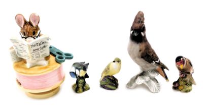 Four bird ornaments, comprising a Goebel European goldfinch, 18cm high, a Royal Worcester wood warbl