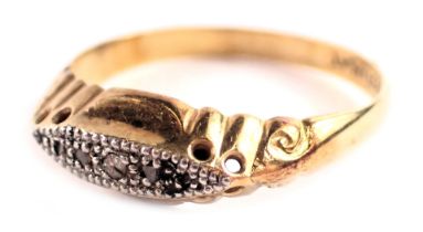 An Edwardian diamond gypsy ring, set with five tiny diamonds in a platinum claw setting, on a yellow