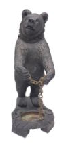 A Black Forest style composition umbrella stand, modelled in the form of a standing bear holding a c