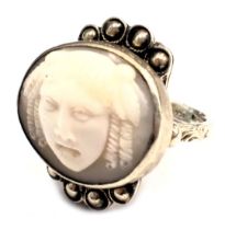 An unusual silver dress ring, the ring head set with oval cameo of Medusa, with a four beaded petala