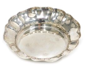 A Queen Elizabeth II silver pin dish, with a moulded floral border, of plain design, maker BES & Co,
