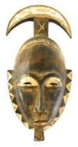 A Baule Diviners 'Crescent' harvest celebration mask, Cote D'Ivoire, 42cm high.