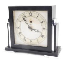 A Smith electric art deco mantel clock, in black and stainless steel case, on a white ground with si
