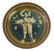 A John Davey studio pottery bowl, decorated with a stylised figure, on a blue ground, impressed mark