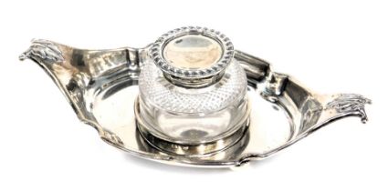 A Victorian silver inkstand, the shaped boat with moulded leaf thumb pieces, with a circular cut gla