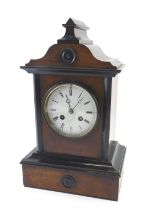 A French walnut and ebonised mantel clock, white enamel dial, on a plinth, 33cm high.