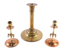 A pair of 19thC Arts and Crafts style copper and brass candlesticks, each with ring handles and engr